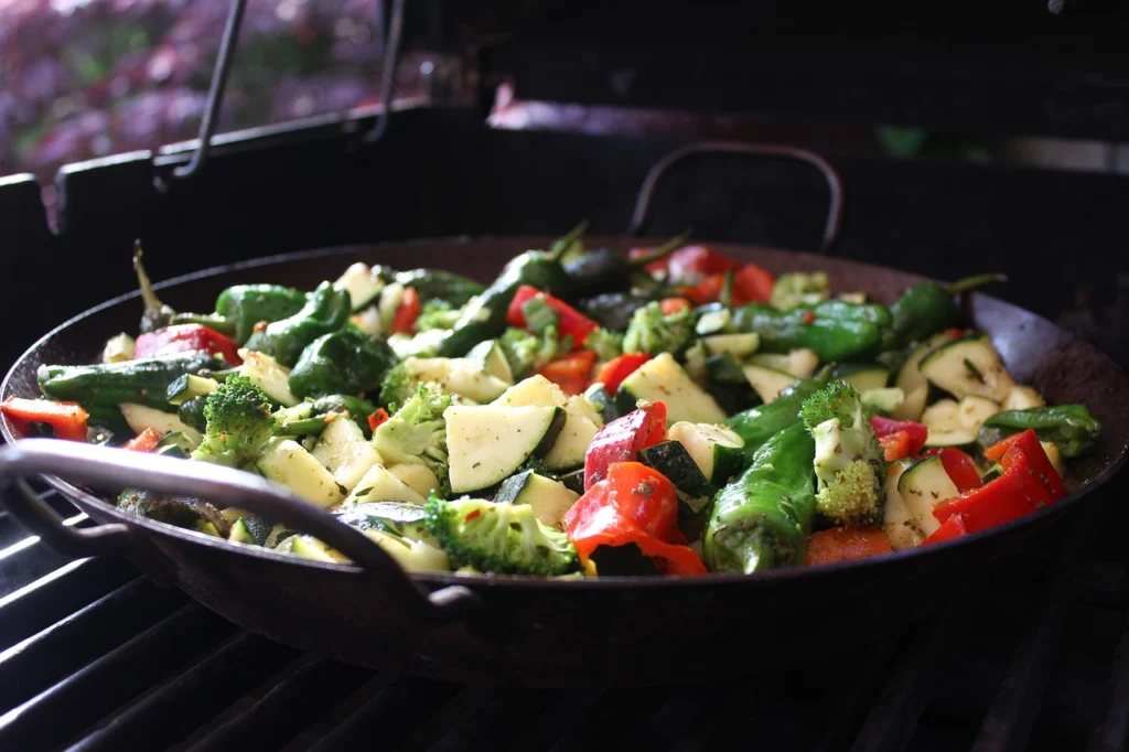 Colorful roasted vegetables spread on a baking sheet, golden brown and caramelized