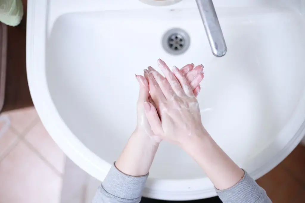 Someone hand washing a nonstick pan with a soft sponge