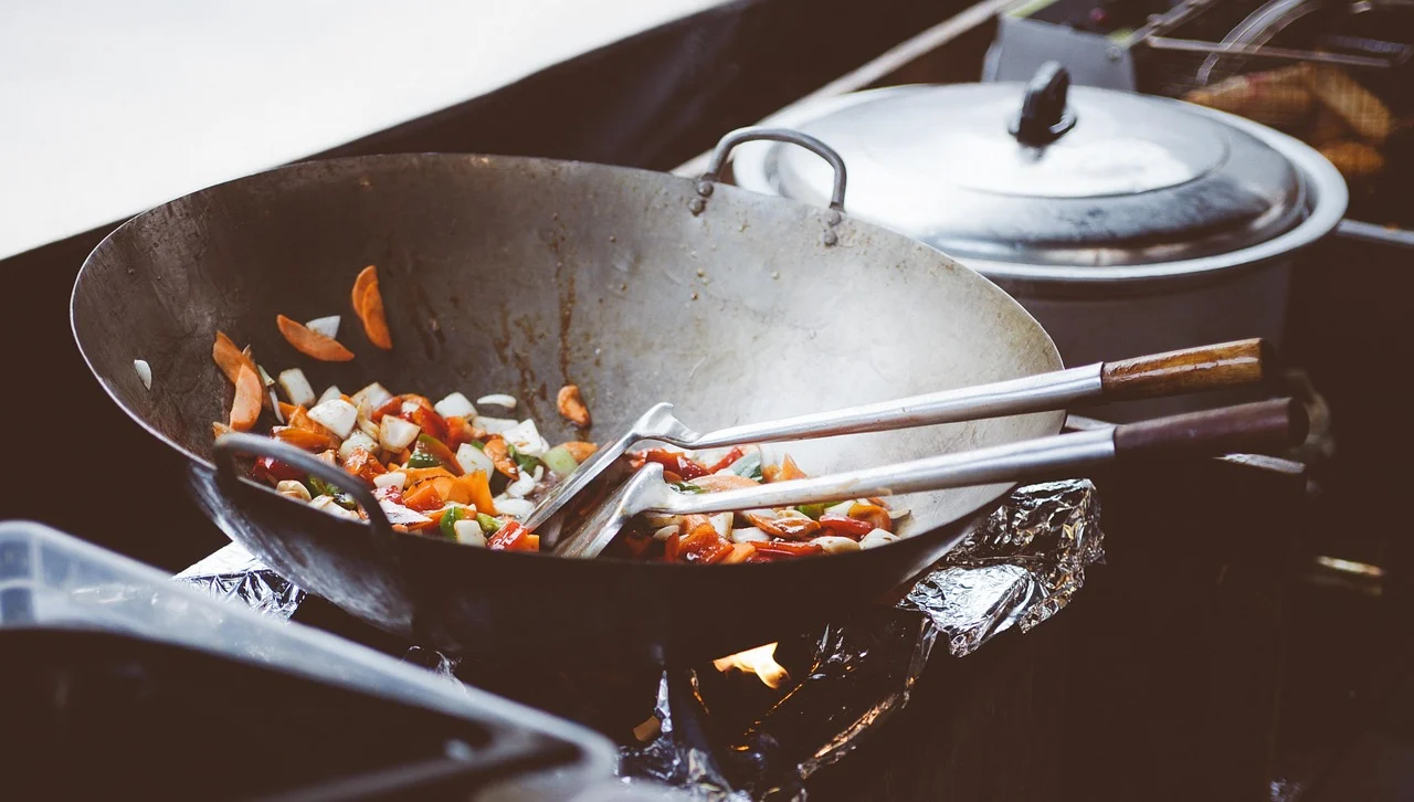 Close-up of a nonstick frying pan with an egg cooking on a stovetop