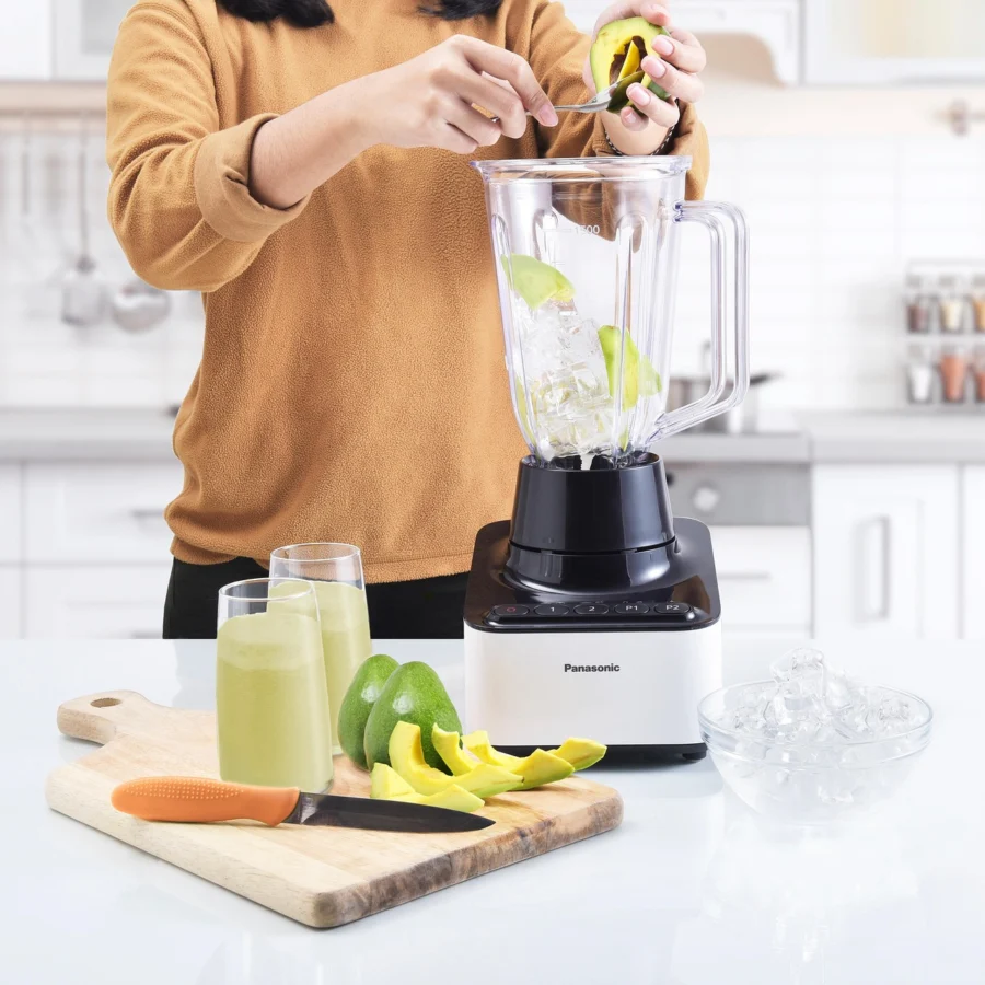 Food processor blending chickpeas and tahini for hummus
